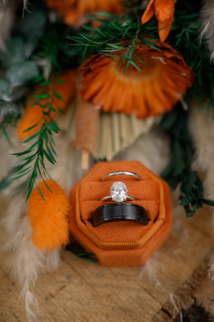 dried bridal bouquet and wedding rings wedding detail